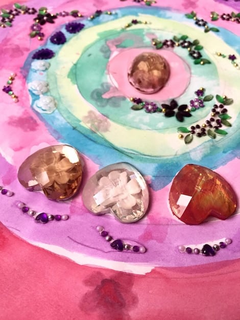 A close-up shot of various colored gemstones (amethyst, rose quartz, citrine, etc.) arranged in a circle, radiating a soft, healing light, symbolizing the therapeutic benefits of color meditation.