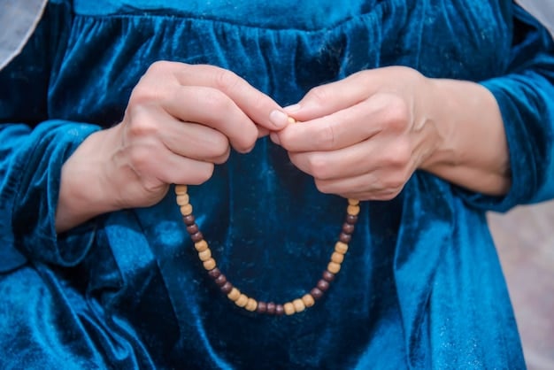 A close-up capture of hands holding prayer beads (mala) with focus on the beads and the natural texture of the wood. Soft, diffused lighting emphasizes the tactile nature of the beads and symbolizes focus and devotion during mantra practice. Background blurred and unobtrusive to keep the focal point on the detail of the mala beads.